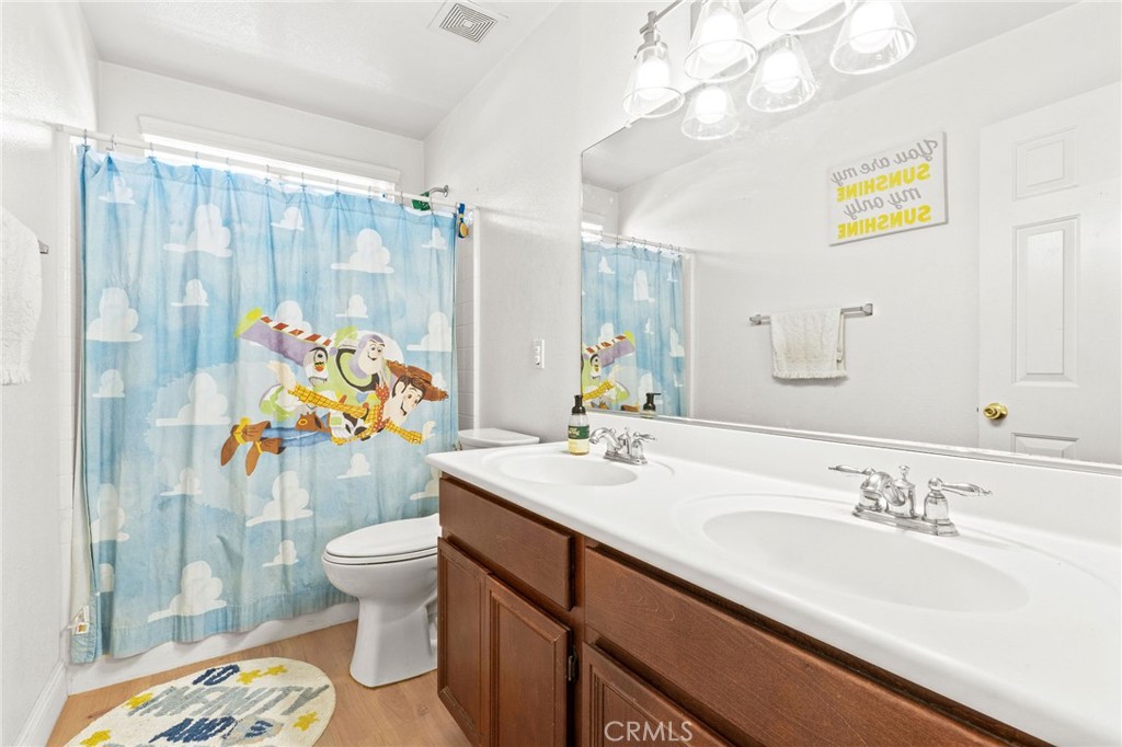 29225 Hydrangea Street Murrieta, CA 92563 - Photo 24 of 38 a bathroom with a sink mirror vanity and toilet