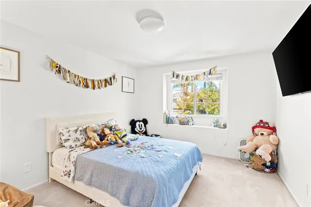 a bedroom with a bed and a tv in it