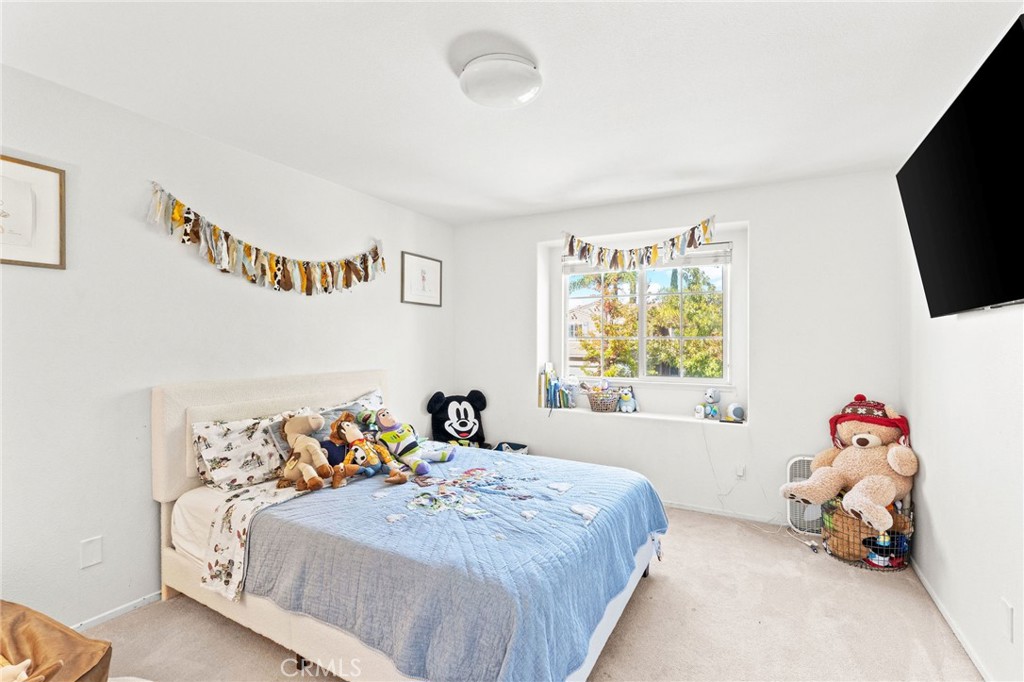 29225 Hydrangea Street Murrieta, CA 92563 - Photo 25 of 38 a bedroom with a bed and a tv in it