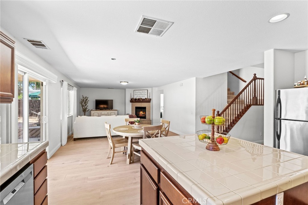 29225 Hydrangea Street Murrieta, CA 92563 - Photo 6 of 38 a living room with furniture a flat screen tv and a table