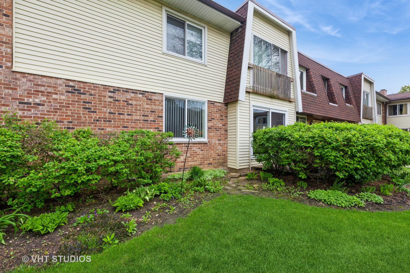 3026 Roberts Drive, Unit 4 Woodridge, IL 60517 - Photo 2 of 19 a view of a brick building next to a yard