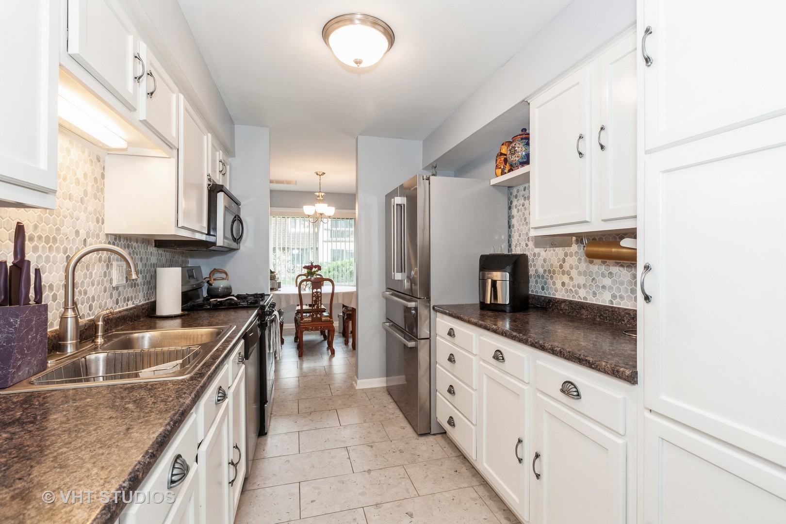 3026 Roberts Drive, Unit 4 Woodridge, IL 60517 - Photo 4 of 19 a kitchen with granite countertop a sink a stove top oven and cabinets