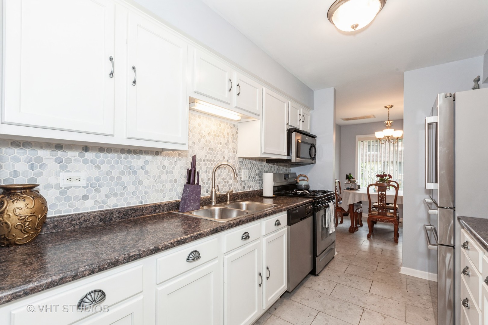 3026 Roberts Drive, Unit 4 Woodridge, IL 60517 - Photo 5 of 19 a kitchen with stainless steel appliances granite countertop a sink stove and refrigerator