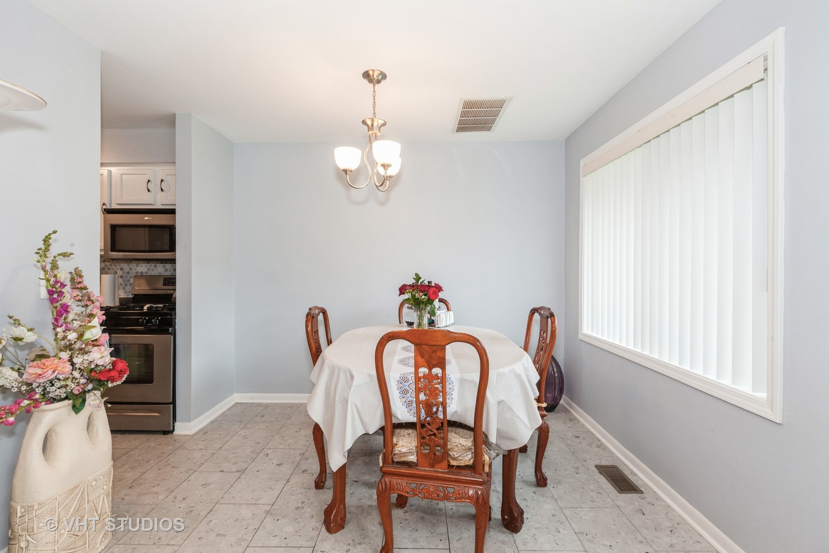 3026 Roberts Drive, Unit 4 Woodridge, IL 60517 - Photo 6 of 19 a view of a dining room with furniture and chandelier