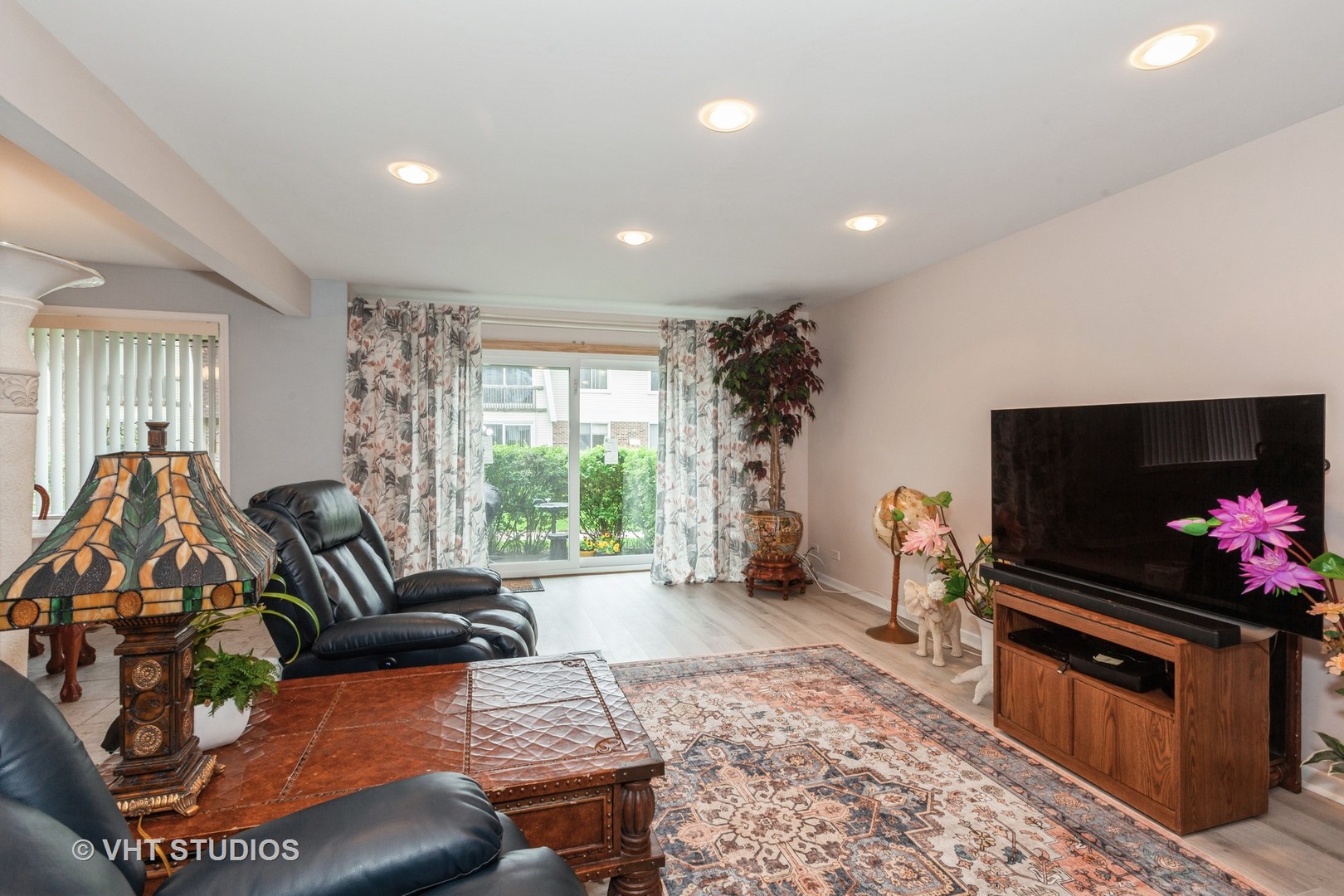3026 Roberts Drive, Unit 4 Woodridge, IL 60517 - Photo 7 of 19 a living room with furniture and a flat screen tv
