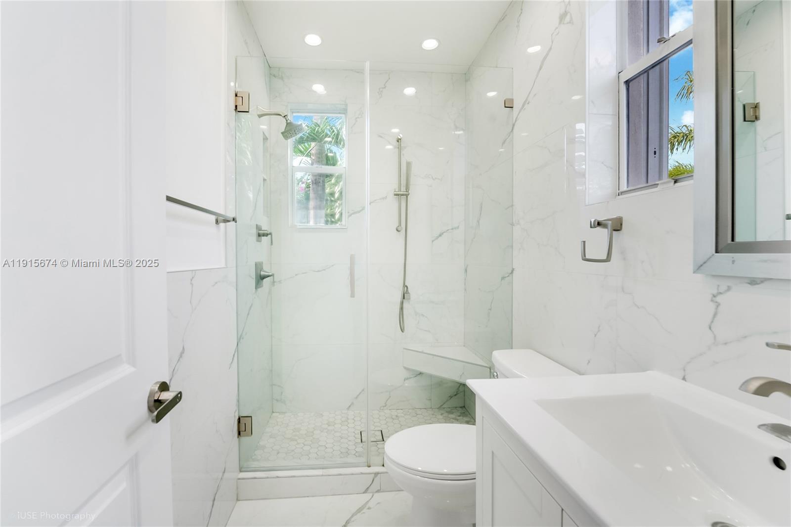 2970 Bird Avenue, Unit 15 Miami, FL 33133 - Photo 11 of 18 a bathroom with a sink toilet vanity and shower