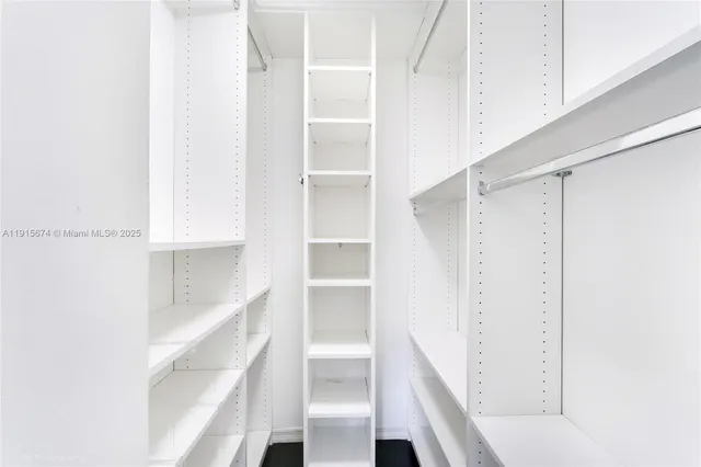 a view of walk in closet with empty racks