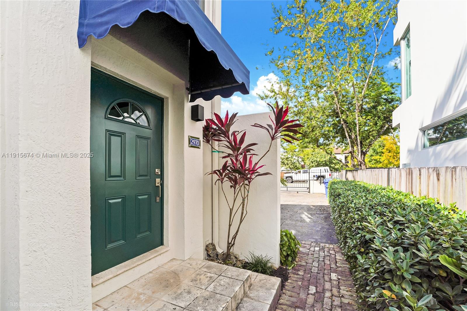 2970 Bird Avenue, Unit 15 Miami, FL 33133 - Photo 17 of 18 a view of a entryway door with flower pots