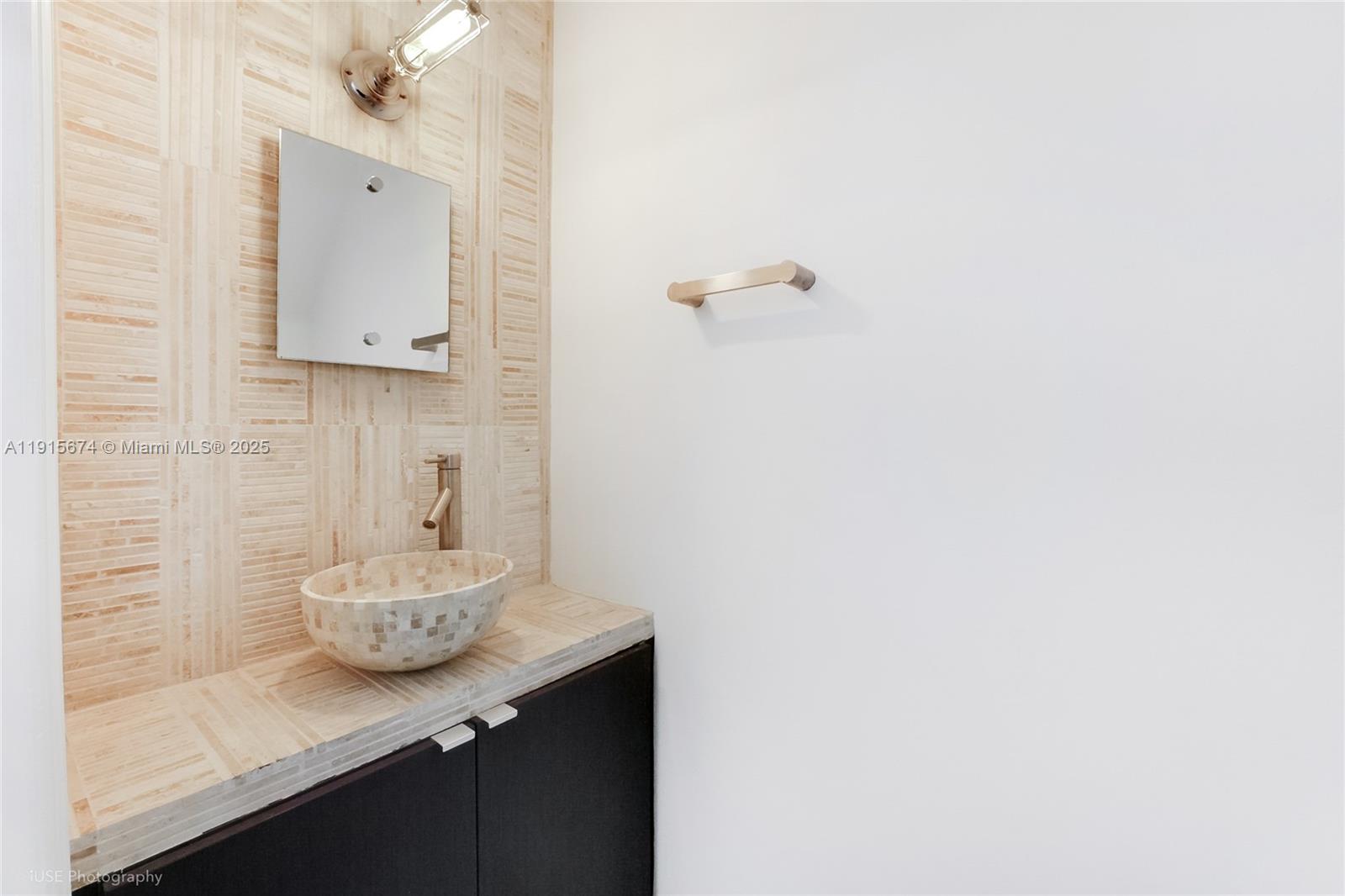 2970 Bird Avenue, Unit 15 Miami, FL 33133 - Photo 5 of 18 a bathroom with a sink and a mirror