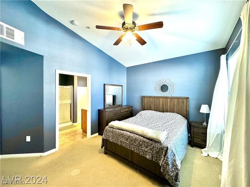 8777 West Maule Avenue, Unit 2103 Las Vegas, NV 89148 - Photo 13 of 33 Carpeted bedroom featuring ceiling fan, ensuite bath, and high vaulted ceiling