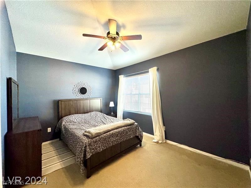 8777 West Maule Avenue, Unit 2103 Las Vegas, NV 89148 - Photo 15 of 33 Bedroom featuring a textured ceiling, carpet flooring, a ceiling fan, and lofted ceiling