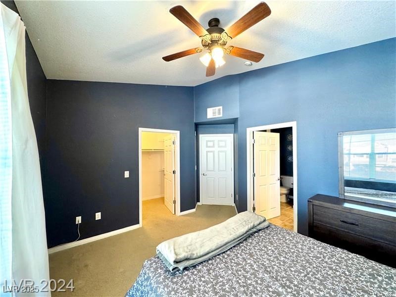 8777 West Maule Avenue, Unit 2103 Las Vegas, NV 89148 - Photo 16 of 33 Bedroom featuring a spacious closet, carpet floors, and ceiling fan