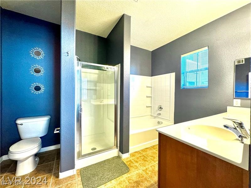 8777 West Maule Avenue, Unit 2103 Las Vegas, NV 89148 - Photo 20 of 33 Full bath featuring vanity, a shower stall, a bath, a textured wall, and light tile patterned flooring