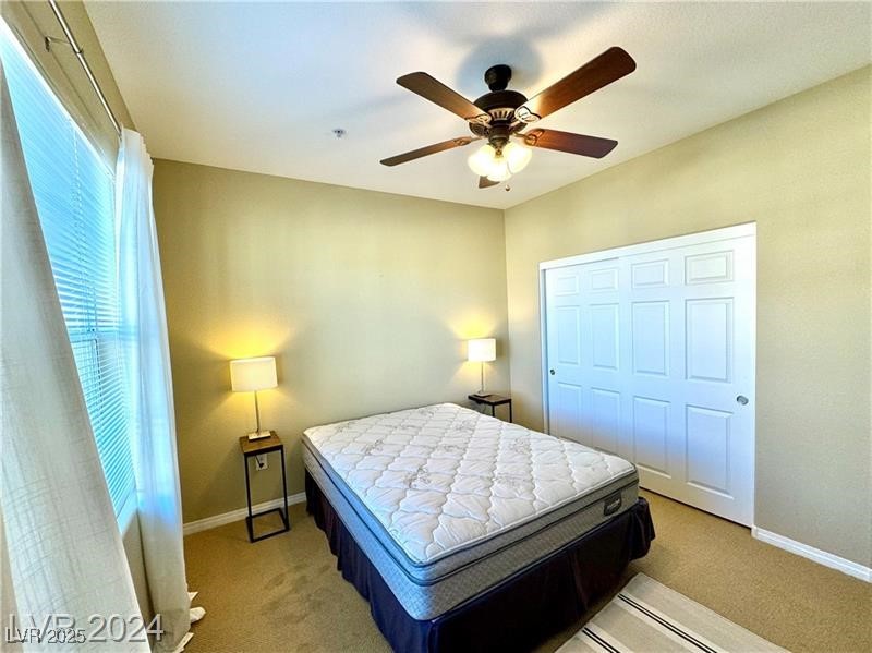 8777 West Maule Avenue, Unit 2103 Las Vegas, NV 89148 - Photo 22 of 33 Bedroom with carpet flooring, ceiling fan, and a closet