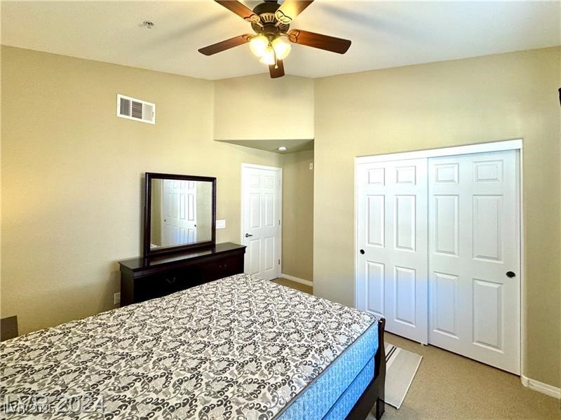 8777 West Maule Avenue, Unit 2103 Las Vegas, NV 89148 - Photo 26 of 33 Bedroom featuring carpet flooring, a closet, and a ceiling fan