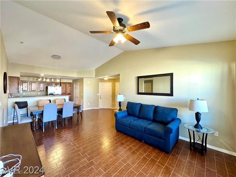 8777 West Maule Avenue, Unit 2103 Las Vegas, NV 89148 - Photo 4 of 33 Living area featuring vaulted ceiling, dark wood-type flooring, and a ceiling fan