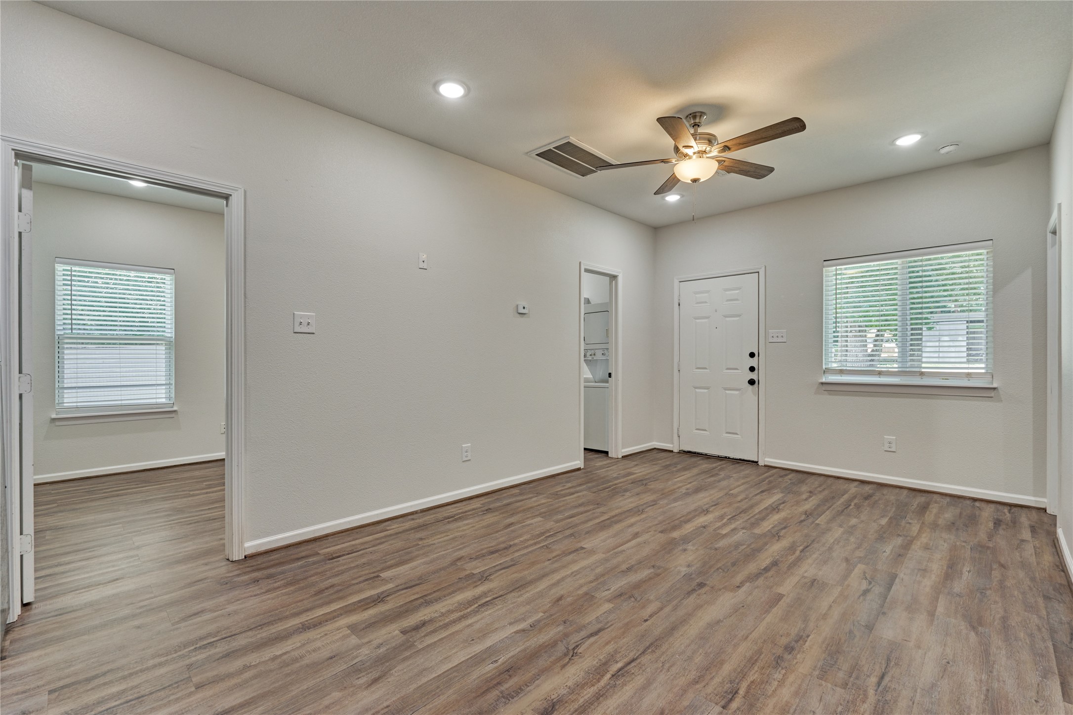 18147 Firepine Lane Montgomery, TX 77316 - Photo 11 of 25 a view of an empty room with wooden floor and a window