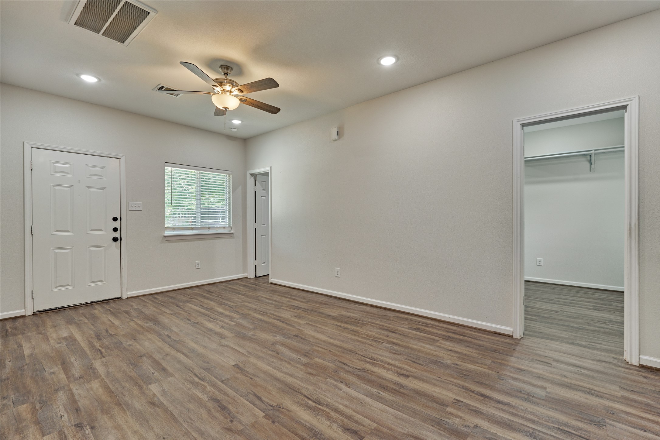 18147 Firepine Lane Montgomery, TX 77316 - Photo 12 of 25 a view of an empty room with wooden floor and a window