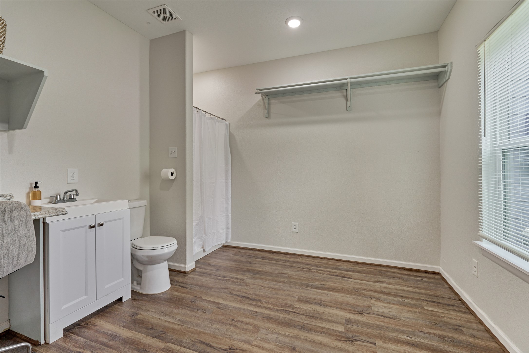 18147 Firepine Lane Montgomery, TX 77316 - Photo 13 of 25 a view of a bathroom with toilet a sink and a window