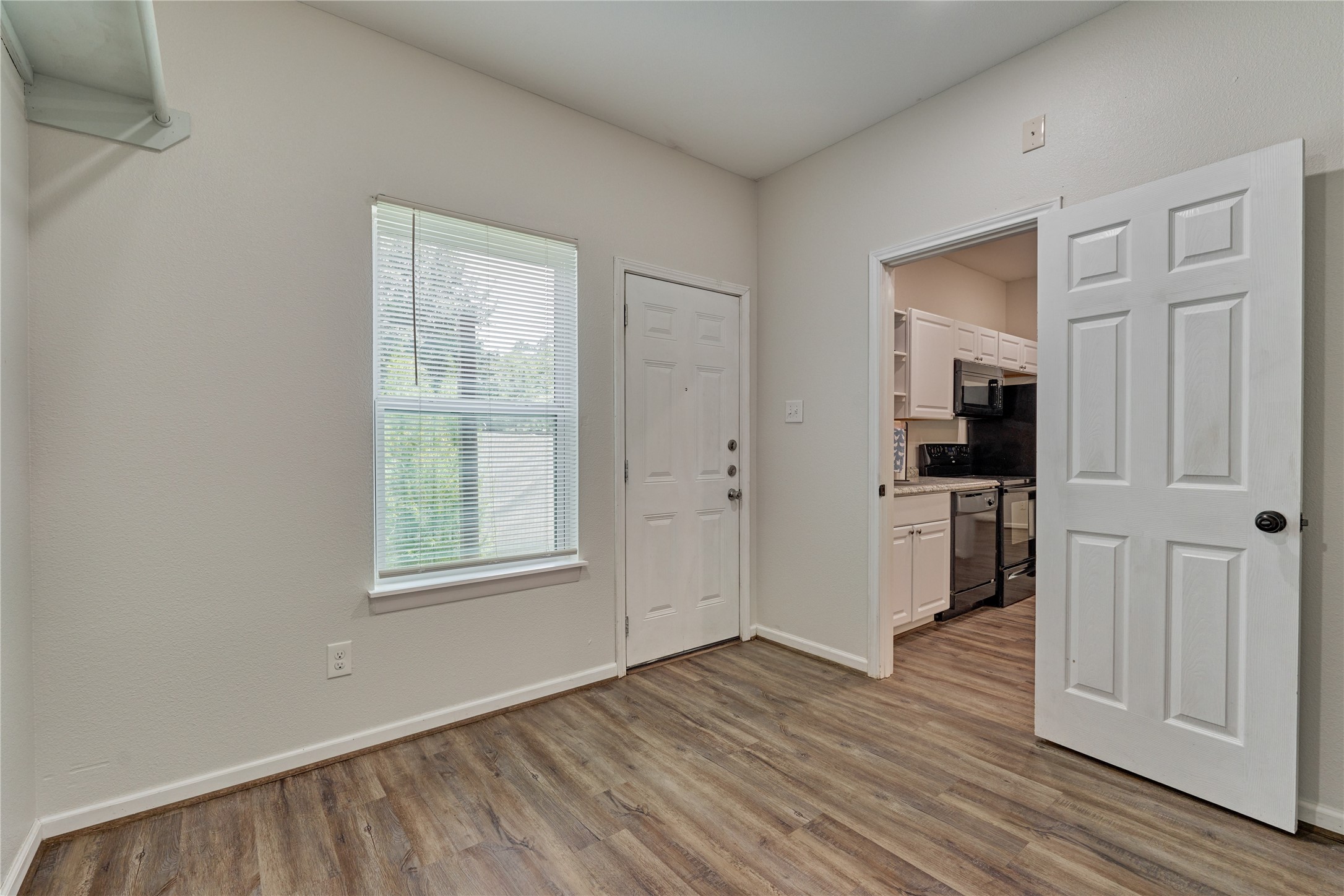 18147 Firepine Lane Montgomery, TX 77316 - Photo 15 of 25 an empty room with wooden floor and windows