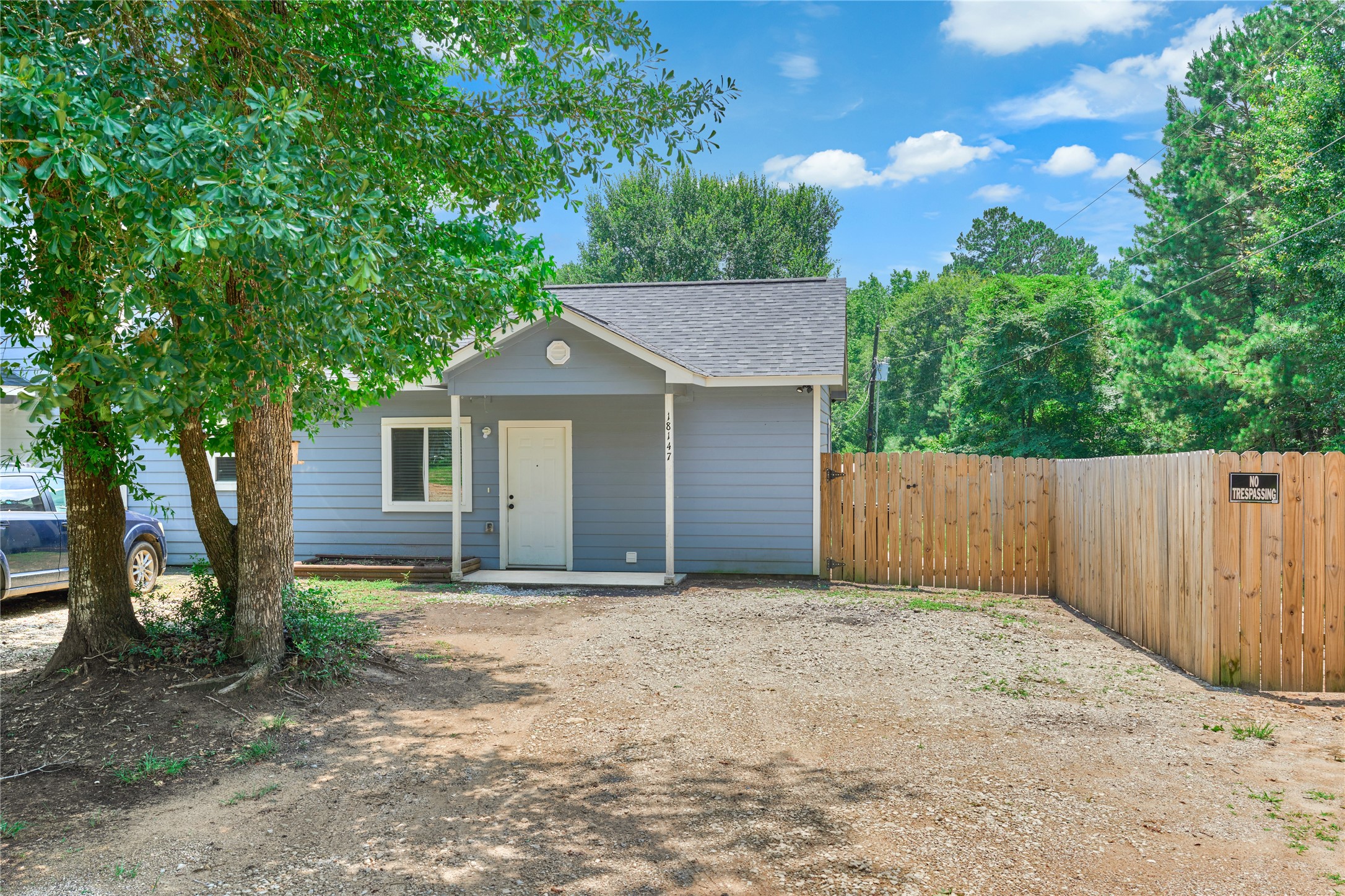 18147 Firepine Lane Montgomery, TX 77316 - Photo 2 of 25 a front view of house with yard and trees in the background
