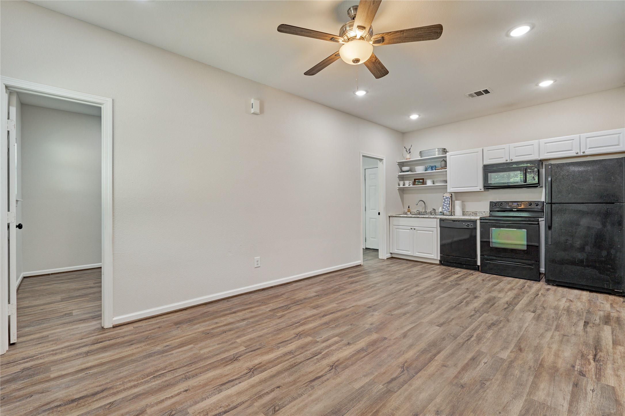 18147 Firepine Lane Montgomery, TX 77316 - Photo 7 of 25 a view of a kitchen with microwave and stainless steel appliances