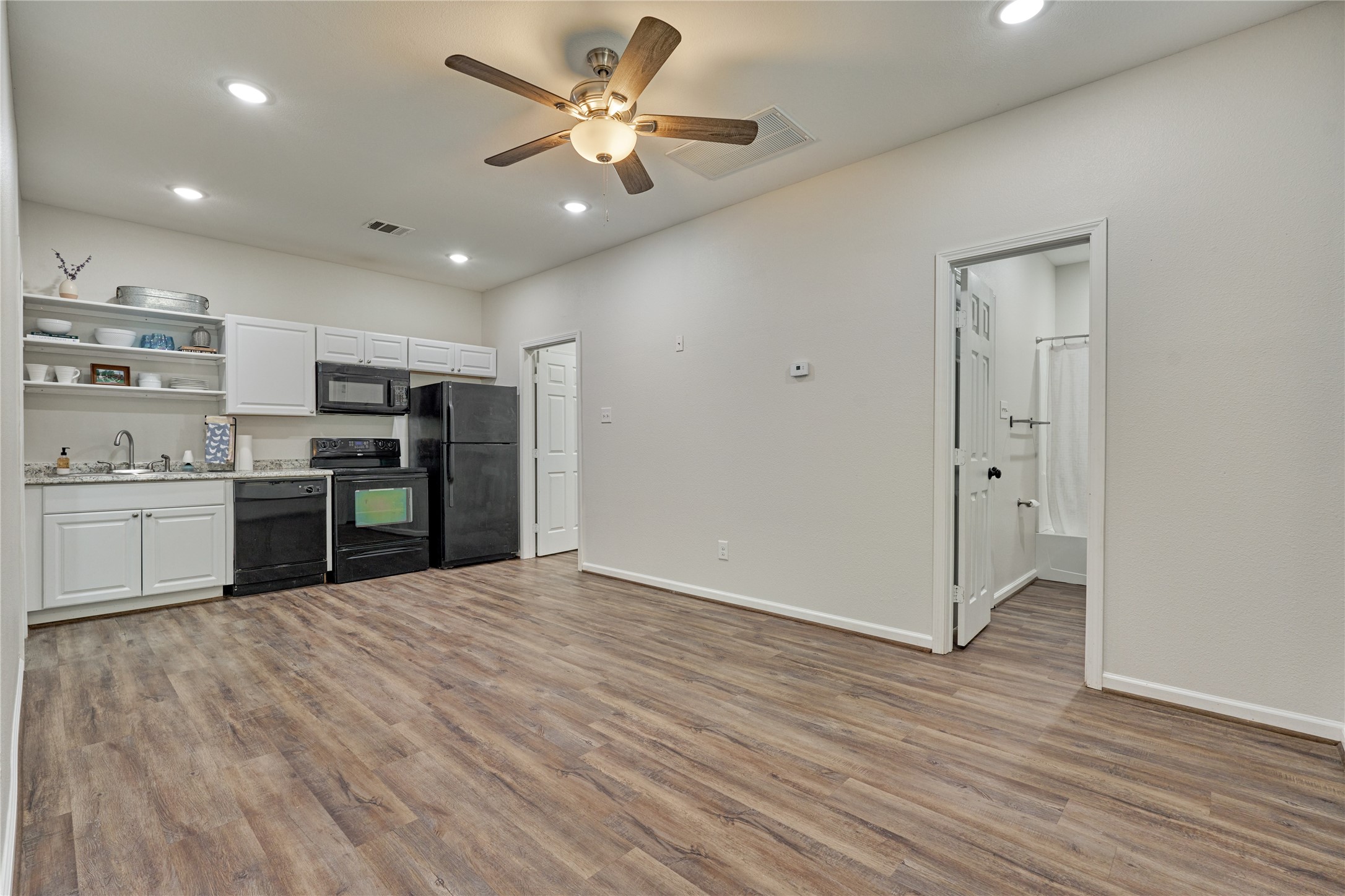 18147 Firepine Lane Montgomery, TX 77316 - Photo 8 of 25 a view of kitchen with granite countertop cabinets and stainless steel appliances