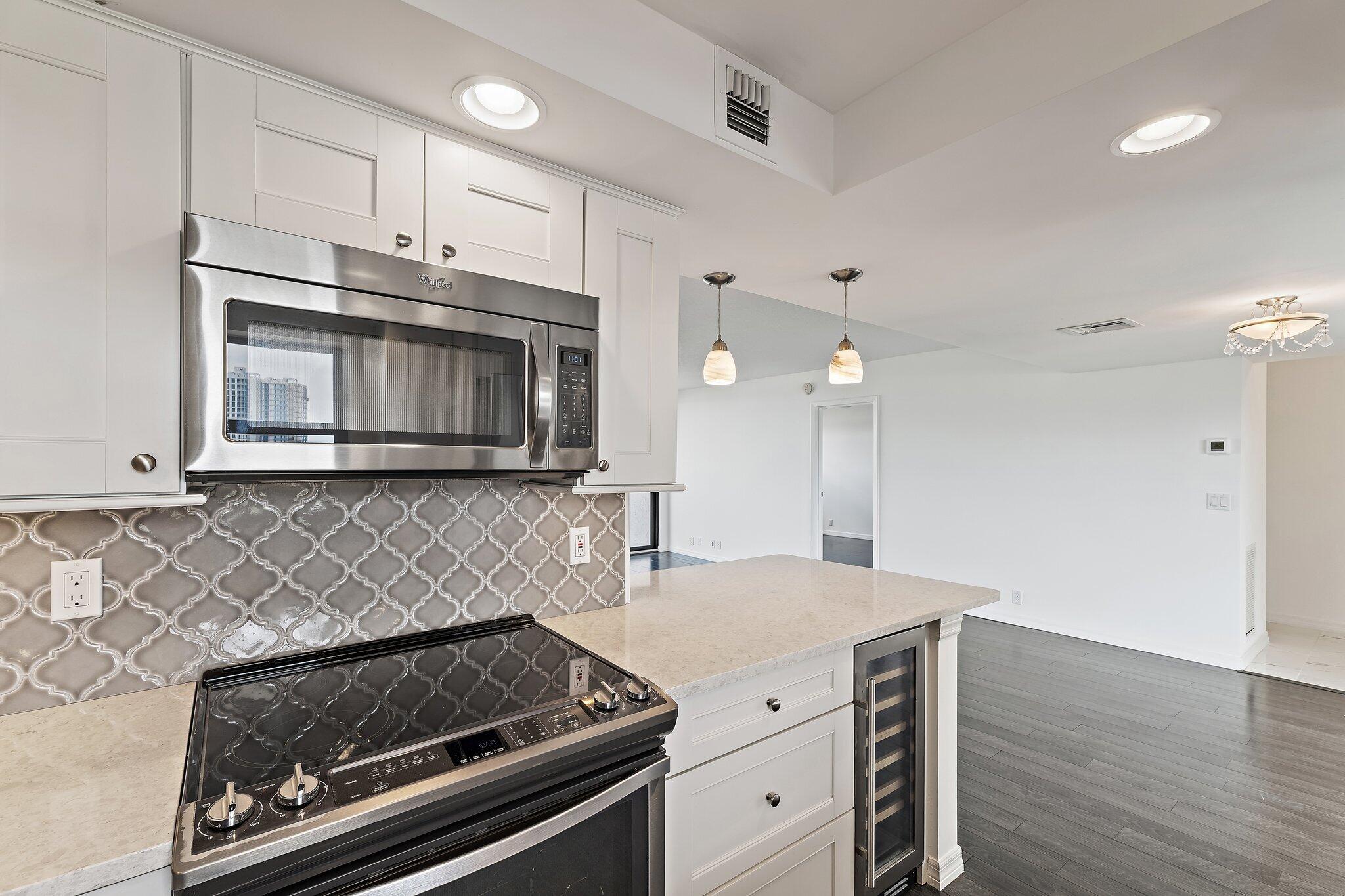 336 Golfview Road, Unit 719 North Palm Beach, FL 33408 - Photo 11 of 72 a kitchen with granite countertop a stove and a microwave