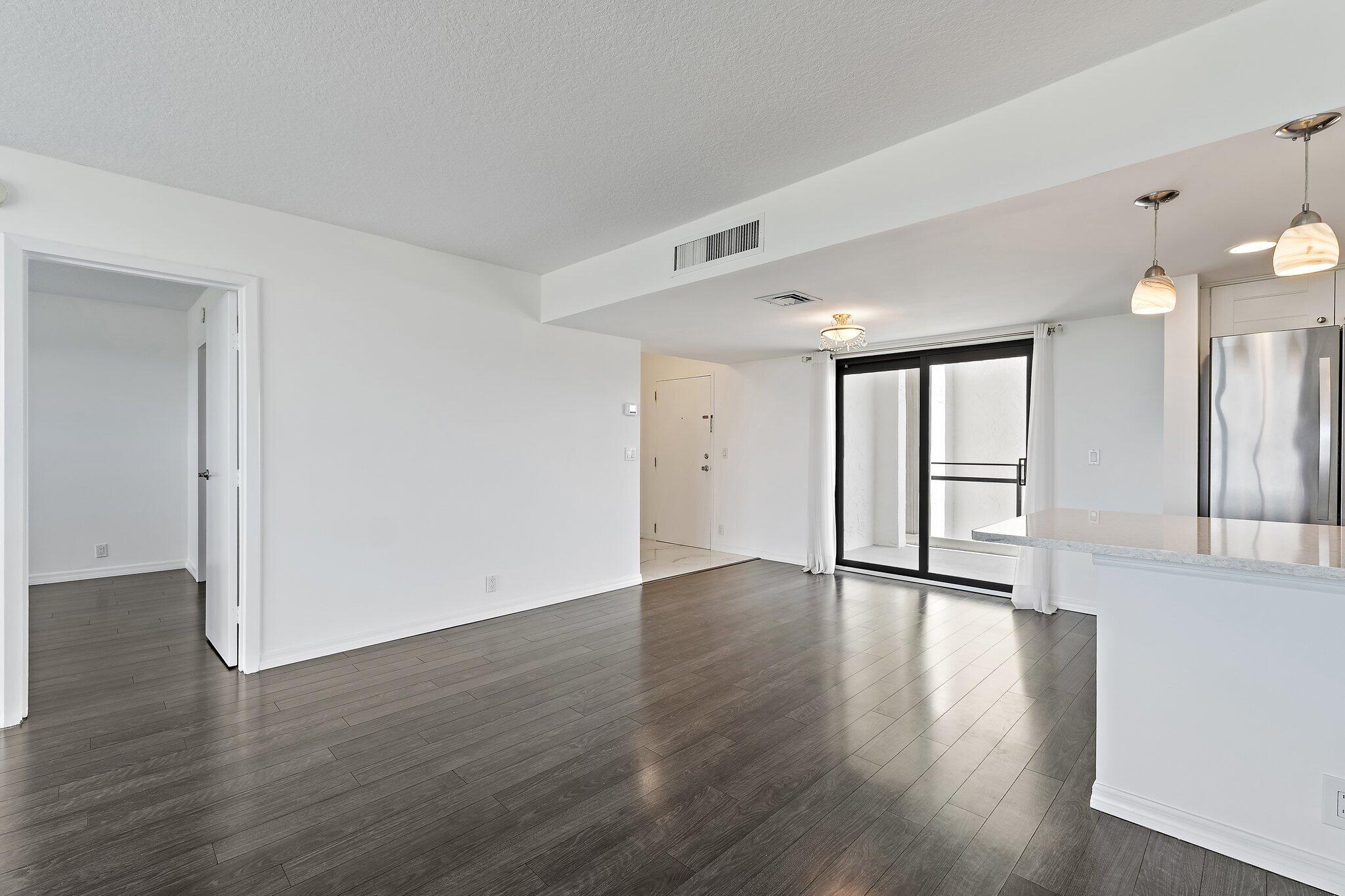 336 Golfview Road, Unit 719 North Palm Beach, FL 33408 - Photo 14 of 72 a view of an empty room with wooden floor and a window