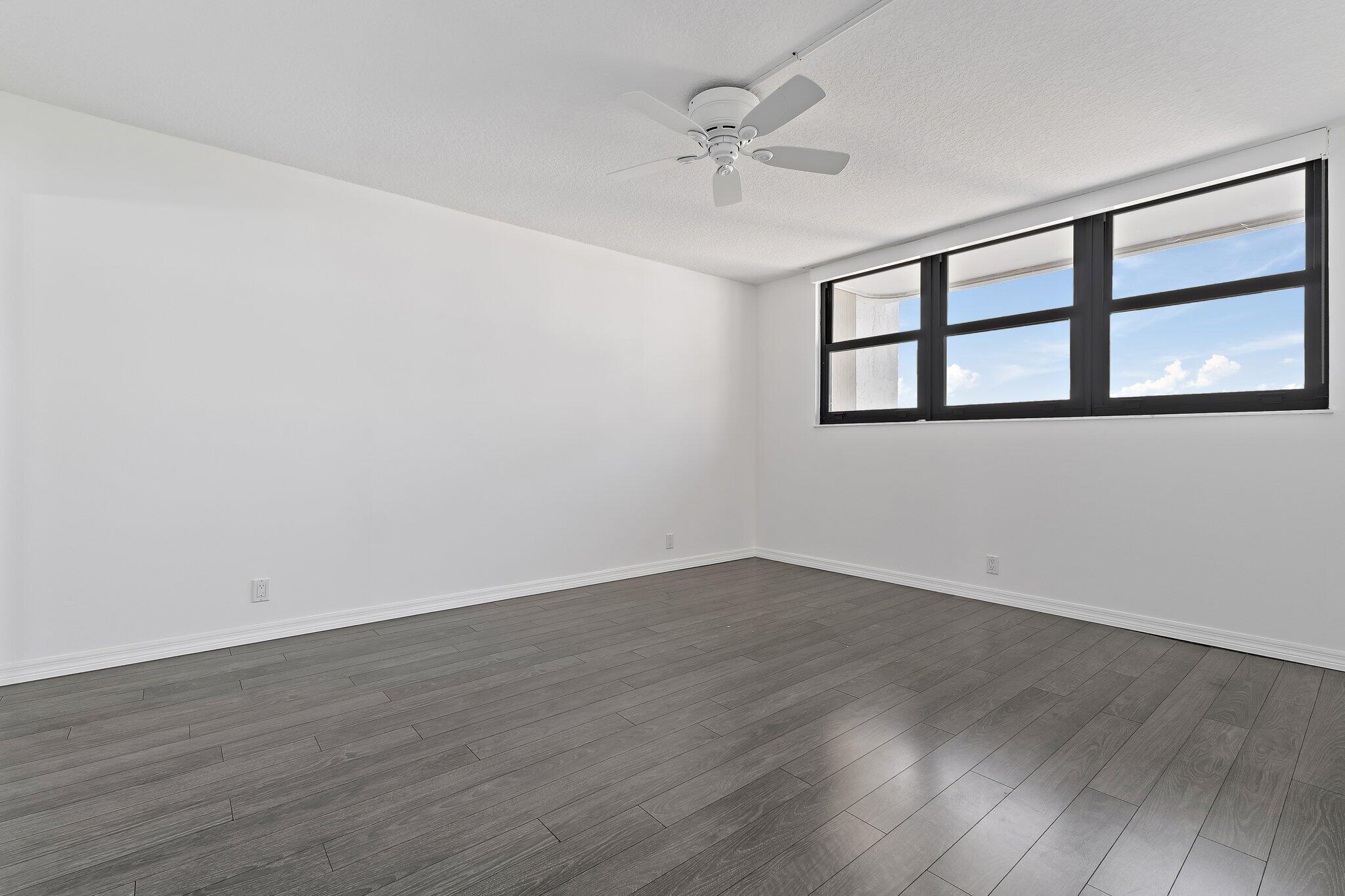 336 Golfview Road, Unit 719 North Palm Beach, FL 33408 - Photo 20 of 72 a view of an empty room with wooden floor and a window