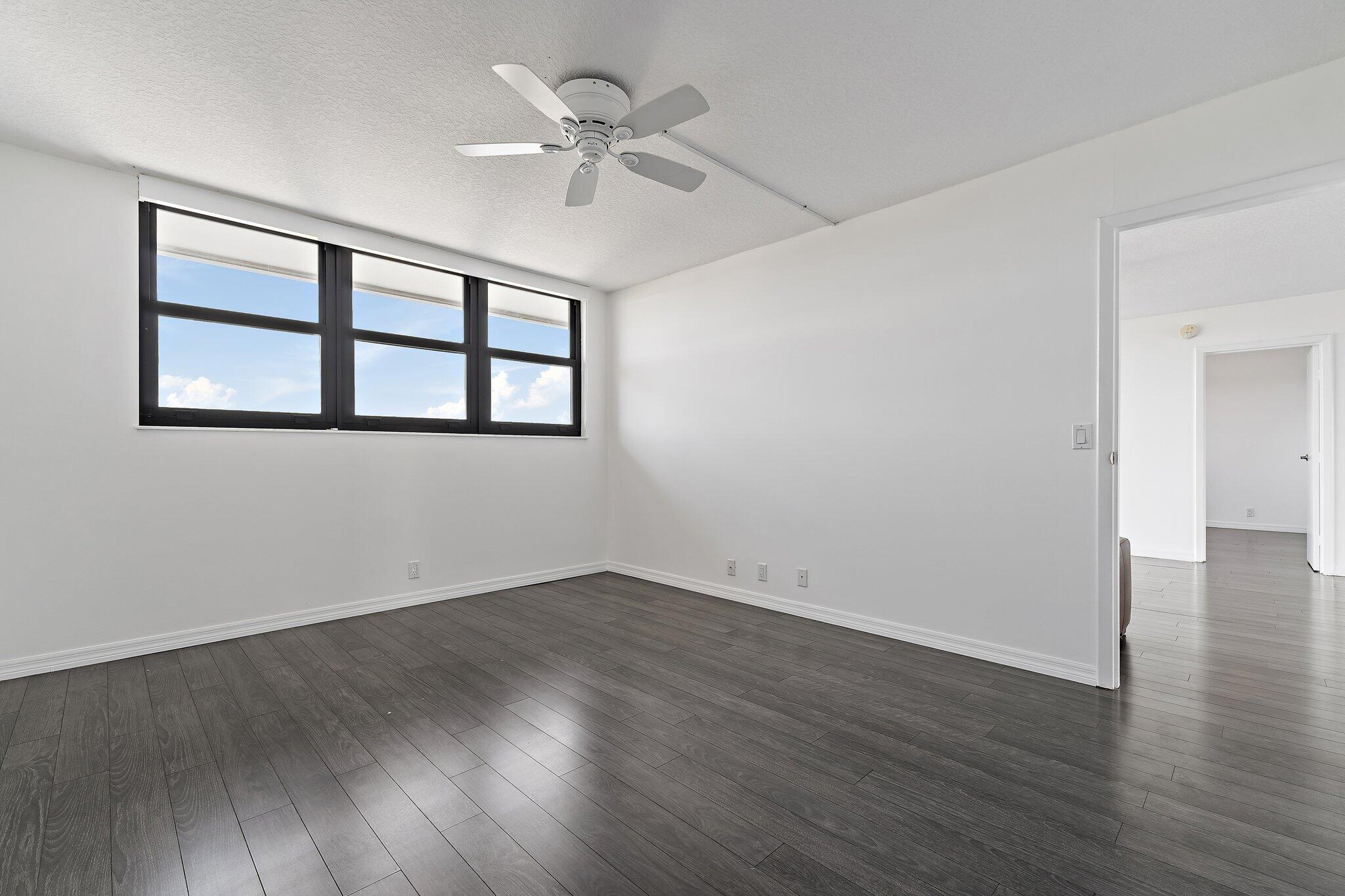 336 Golfview Road, Unit 719 North Palm Beach, FL 33408 - Photo 21 of 72 a view of an empty room with wooden floor and a window