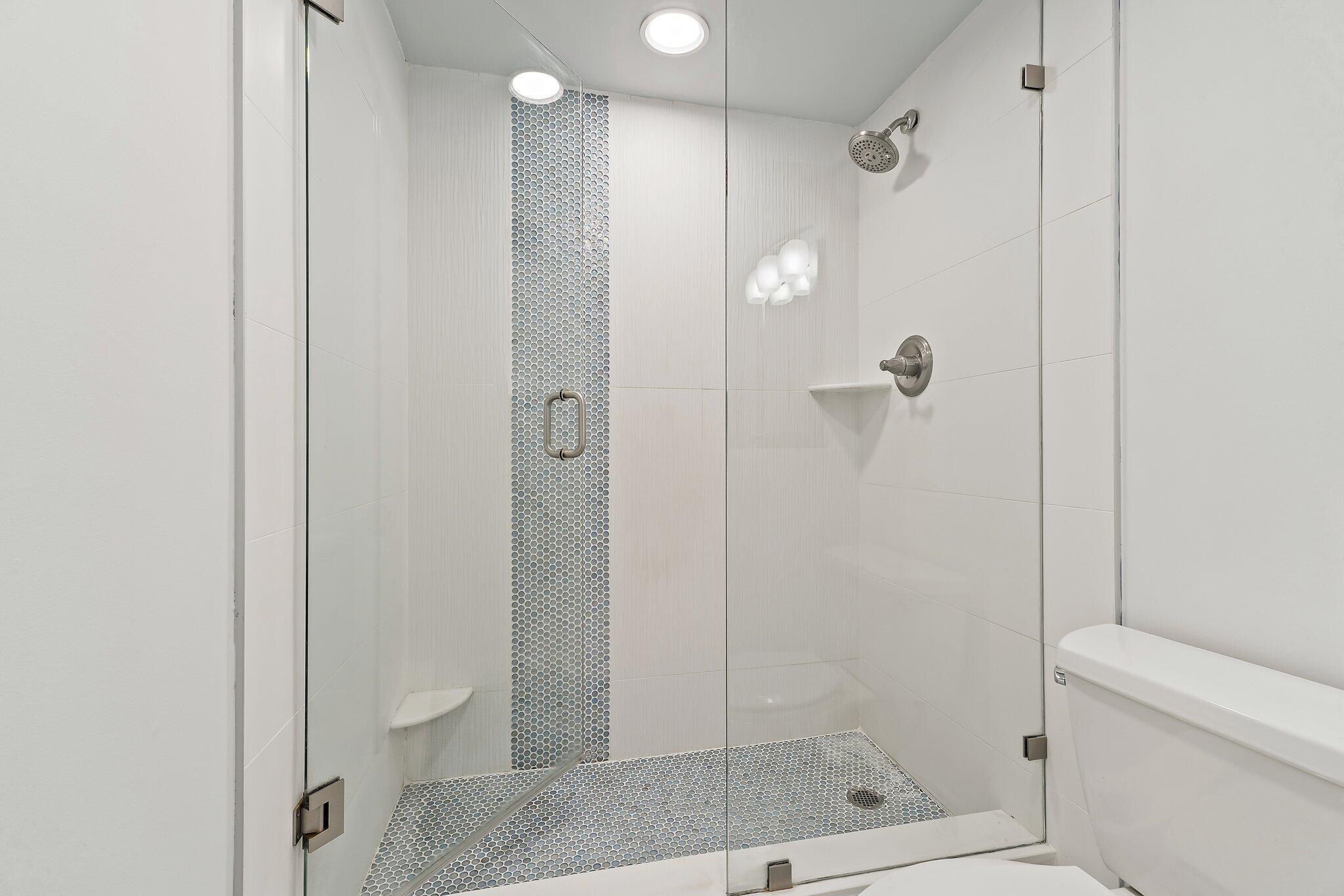 336 Golfview Road, Unit 719 North Palm Beach, FL 33408 - Photo 28 of 72 a bathroom with a shower a toilet and a glass window