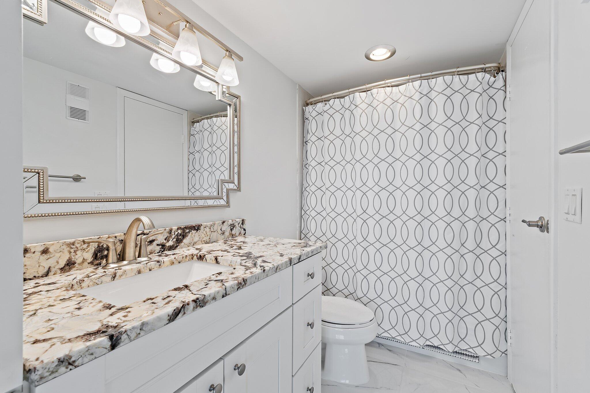 336 Golfview Road, Unit 719 North Palm Beach, FL 33408 - Photo 30 of 72 a bathroom with a sink and a mirror