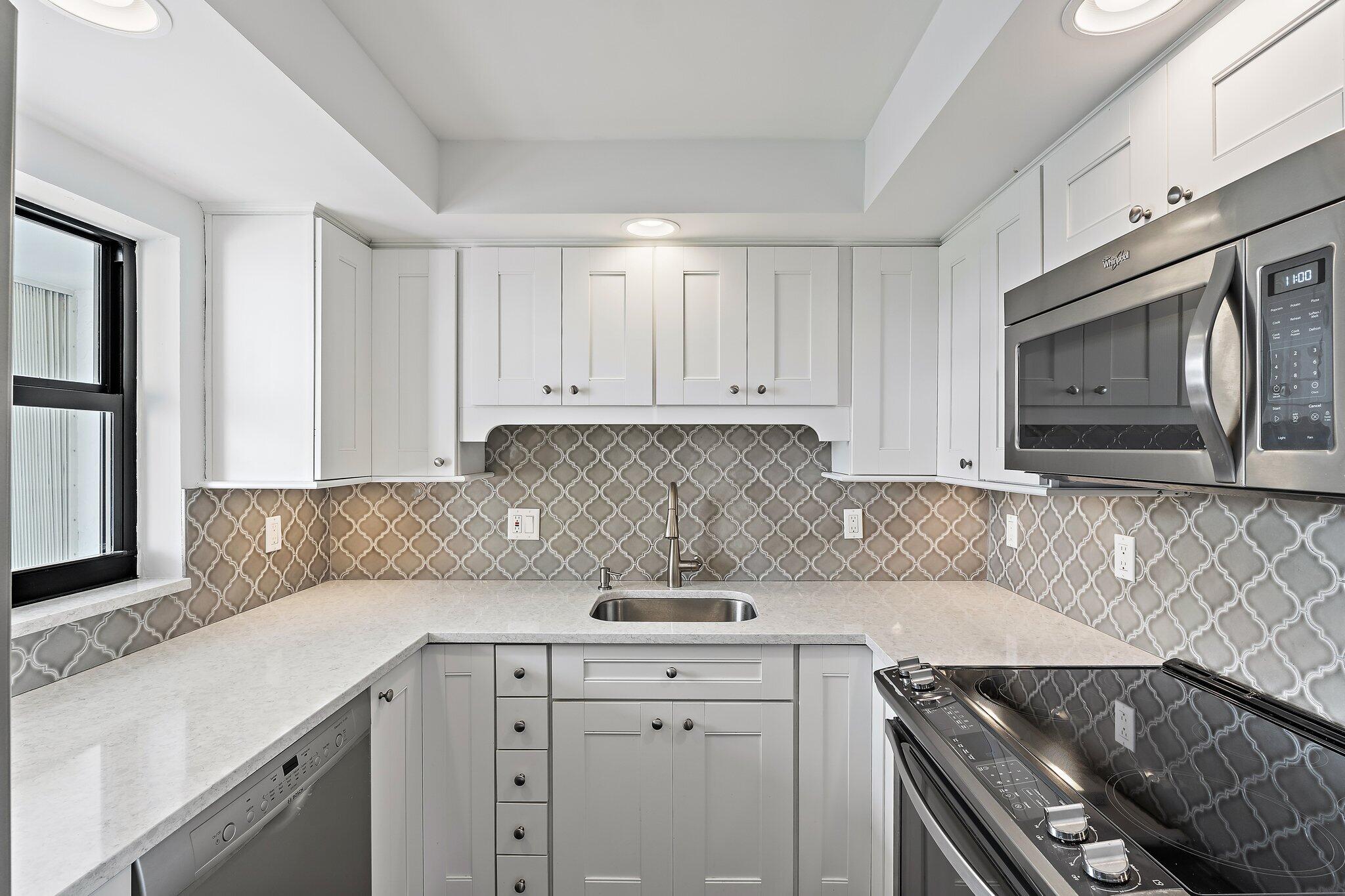 336 Golfview Road, Unit 719 North Palm Beach, FL 33408 - Photo 33 of 72 a kitchen with stainless steel appliances granite countertop a sink stove and cabinets