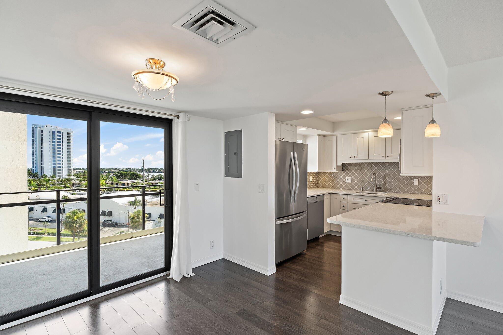336 Golfview Road, Unit 719 North Palm Beach, FL 33408 - Photo 4 of 72 a kitchen with stainless steel appliances granite countertop a refrigerator and a stove top oven