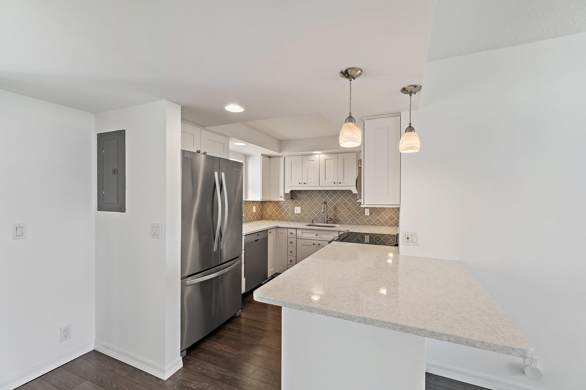 336 Golfview Road, Unit 719 North Palm Beach, FL 33408 - Photo 6 of 72 a kitchen with a sink stainless steel appliances and cabinets