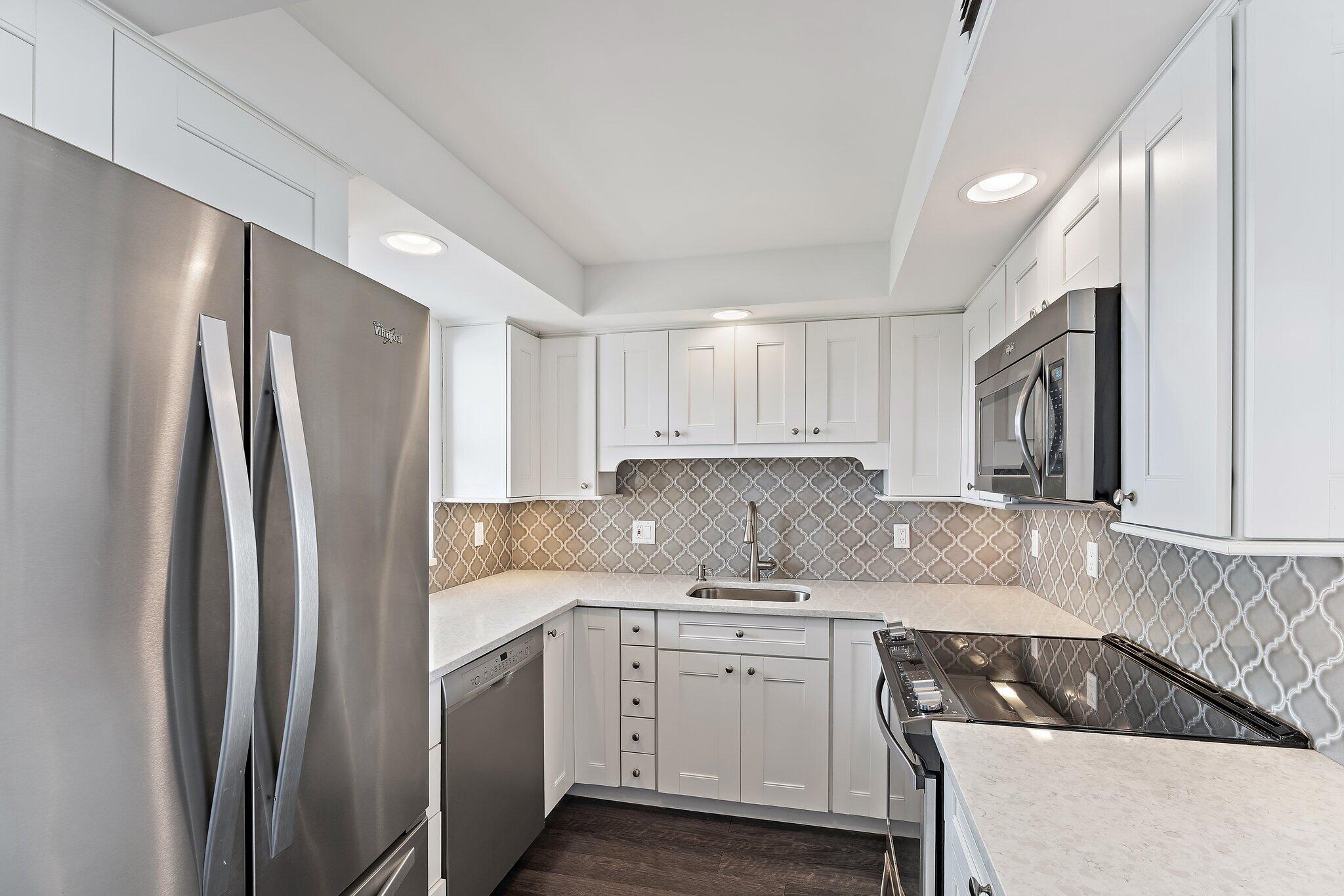 336 Golfview Road, Unit 719 North Palm Beach, FL 33408 - Photo 7 of 72 a kitchen with a refrigerator sink and cabinets