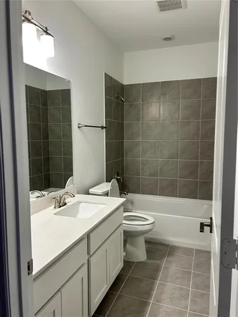 a bathroom with a double vanity sink toilet and shower