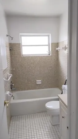a bathroom with a toilet and a bathtub