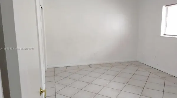 a view of an empty room and window