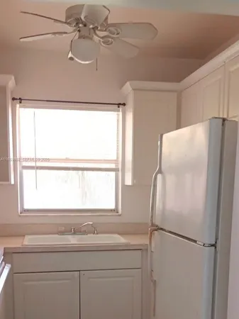 a white refrigerator freezer sitting inside of a kitchen