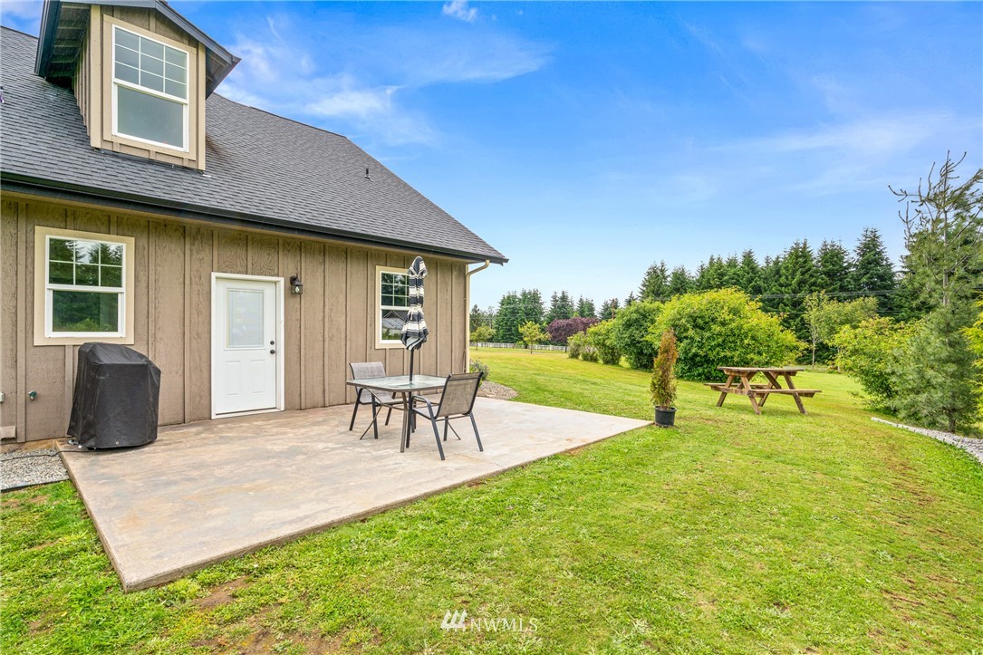 132-12 Pleasant Hill Road Chehalis, WA 98532 - Photo 23 of 25 a view of a backyard with table and chairs and a yard