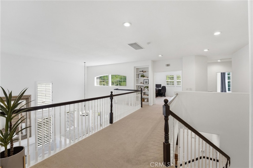 21581 Hummingbird Street Rancho Santa Margarita, CA 92679 - Photo 20 of 56 Spacious Hallway with Primary Bedroom on the Opposite end of Secondary Bedrooms