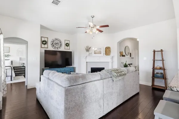 a living room with furniture a flat screen tv and a fireplace
