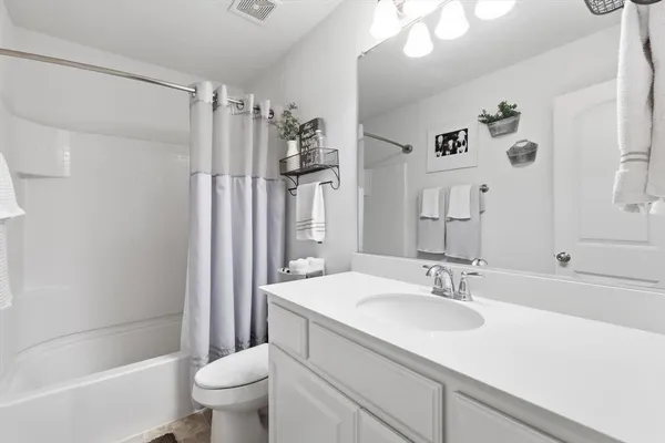 a bathroom with a sink toilet tub and shower