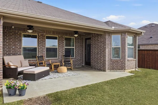 a front view of a house with outdoor seating and plants