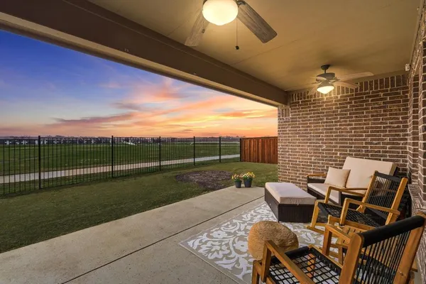 a view of a patio with a dining table and chairs with wooden floor
