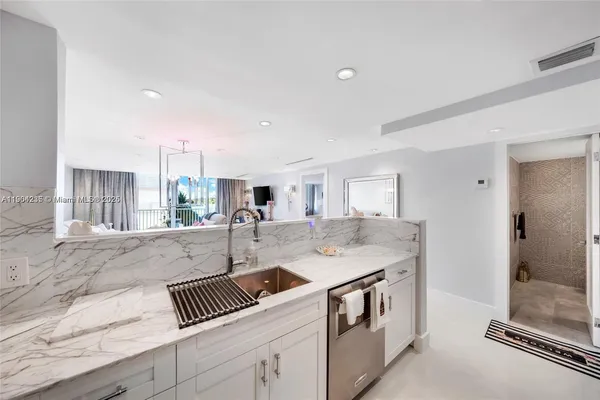a spacious bedroom with a bed and a flat screen tv