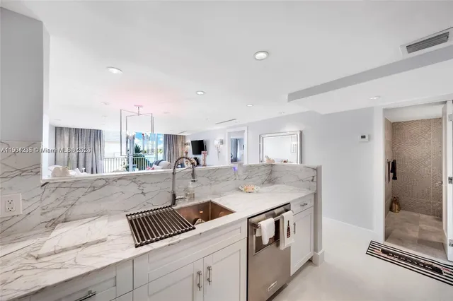 a spacious bedroom with a bed and a flat screen tv