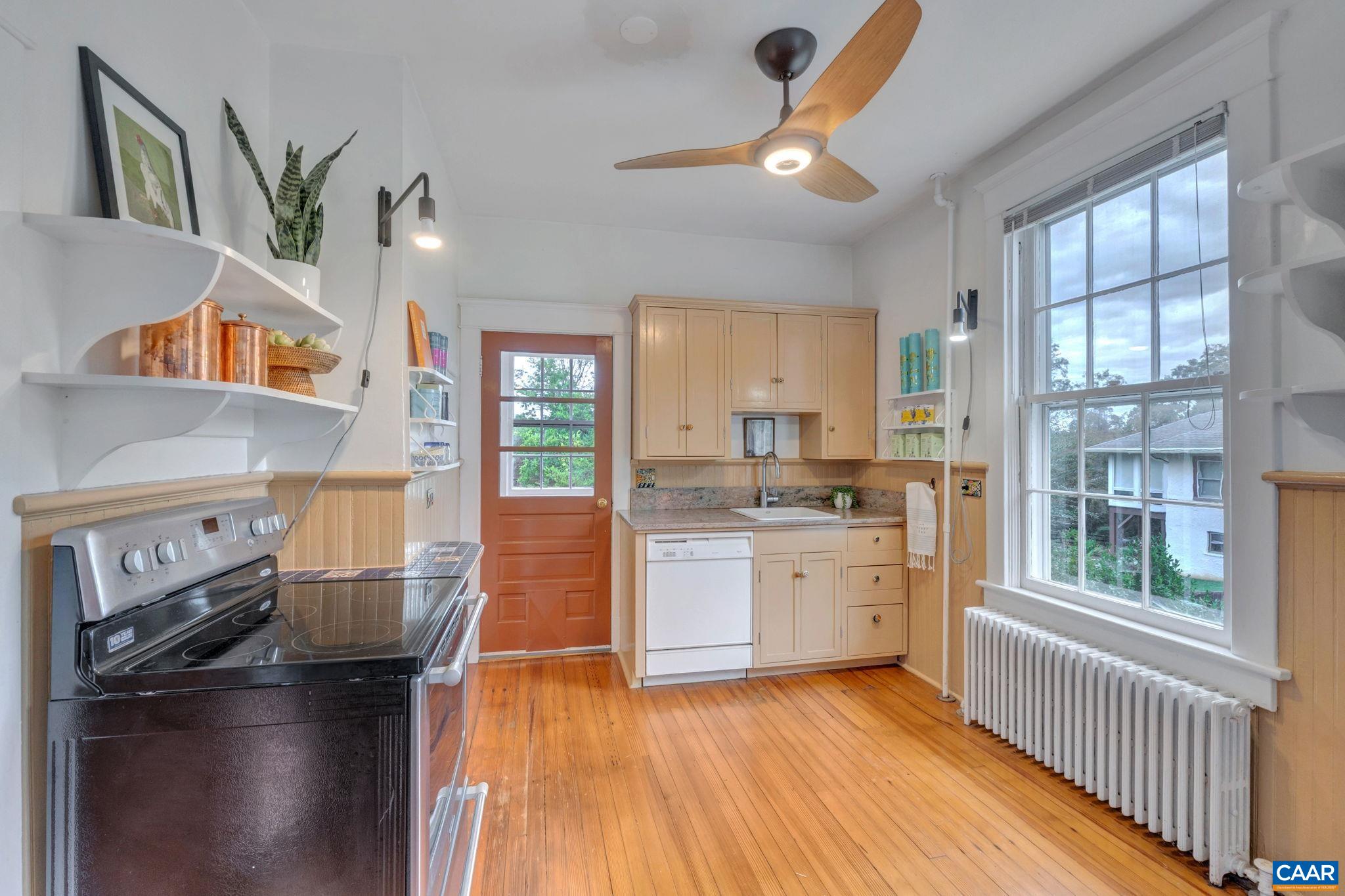 945 Locust Avenue Charlottesville, VA 22901 - Photo 13 of 52 a kitchen with stainless steel appliances granite countertop a stove and a refrigerator
